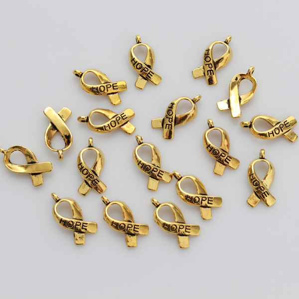 Gold awareness ribbon charms with the word "HOPE" engraved on the ribbon, 18mm long