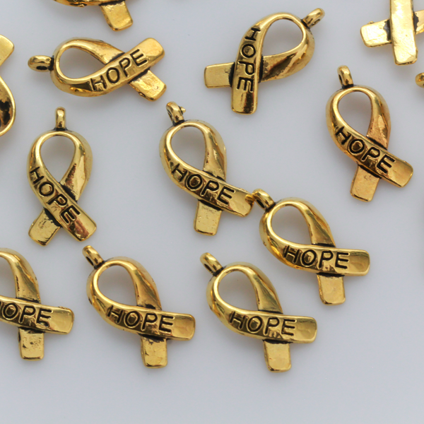 Gold awareness ribbon charms with the word "HOPE" engraved on the ribbon, 18mm long