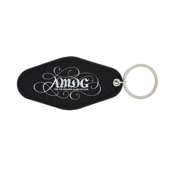 AMDG keychain that is made from black imitation leather with the letters AMDG in white on one side only.
