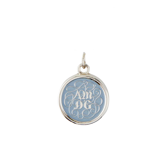 Round pendant with an ornate acronym on the front that is detailed by a light blue enamel color. The acronym ADMG stands for "Ad Majorem Dei Gloriam".