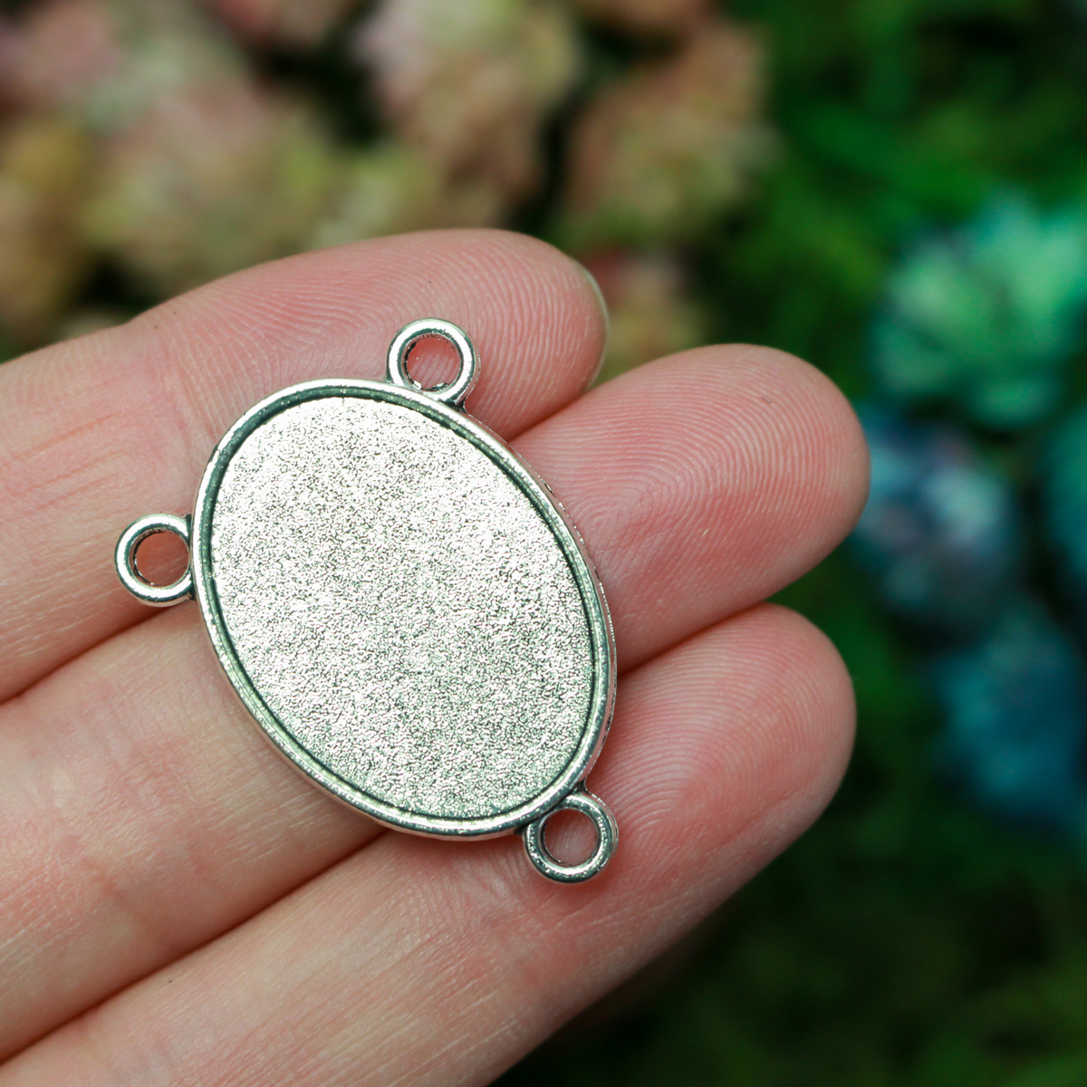 Flat oval rosary centerpiece cabochon setting in an antiqued silver tone color. This is a plain edge bezel cup with a 25mm x 18mm tray