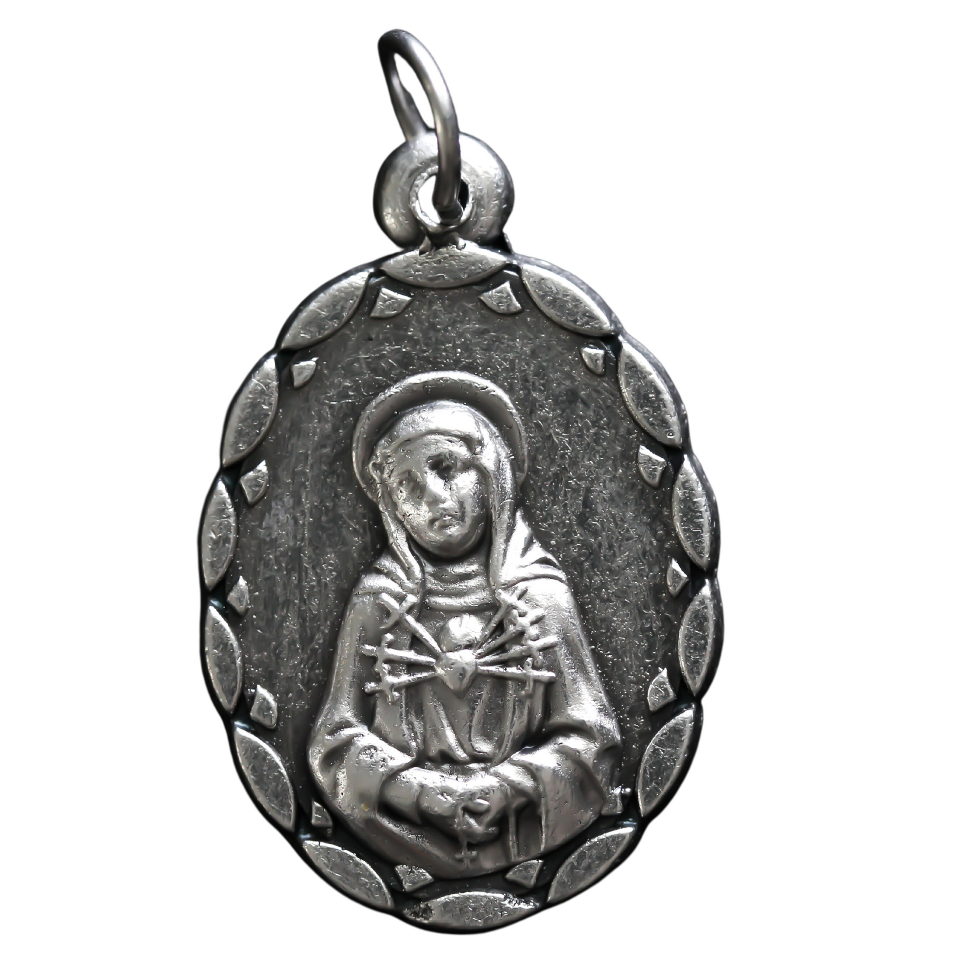 Our Lady of the Seven Sorrows medal that depicts the Virgin Mary on the front, her heart is pierced by seven swords which represent the seven sorrows.