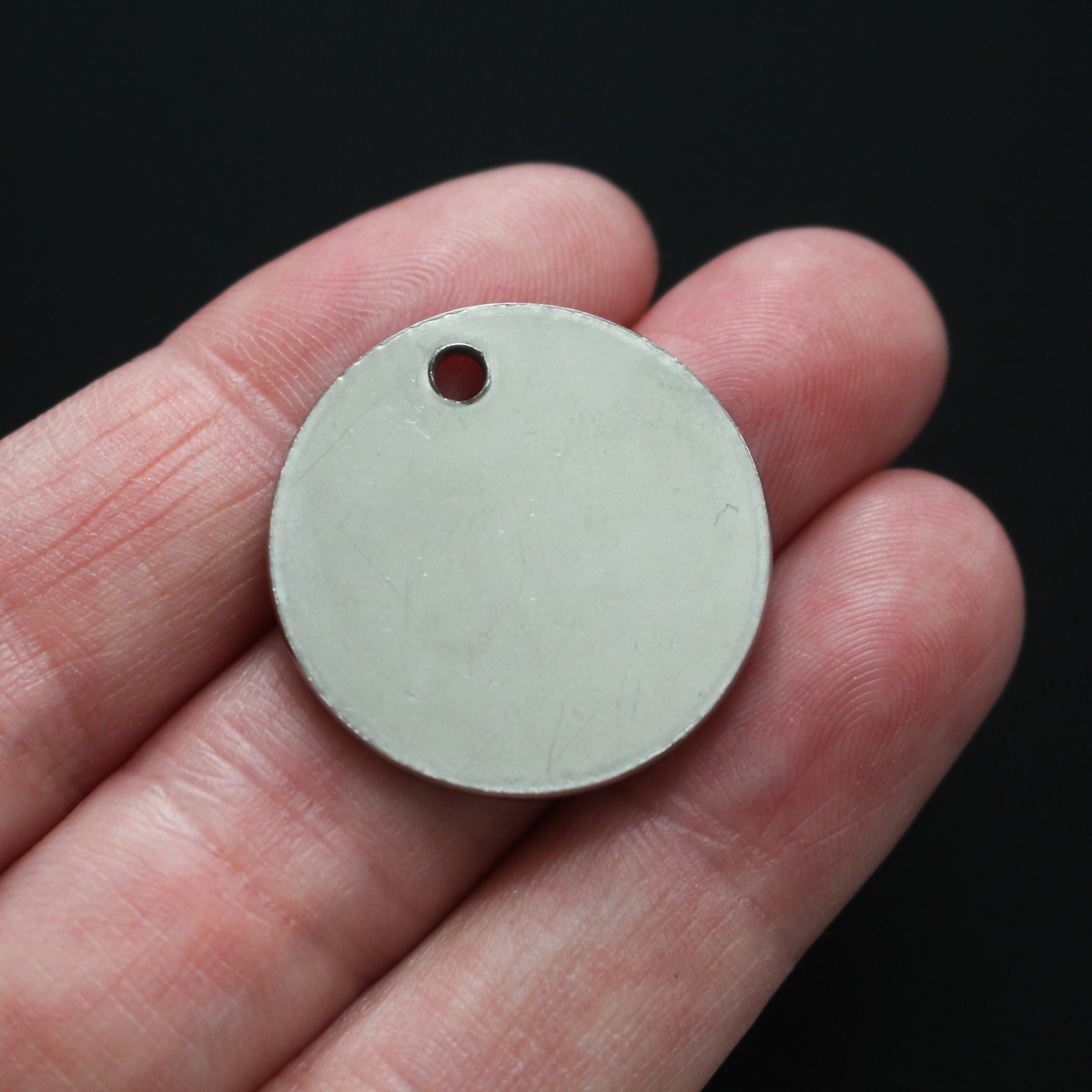 Stainless steel one inch round charm engraved with "Catholic Mama".