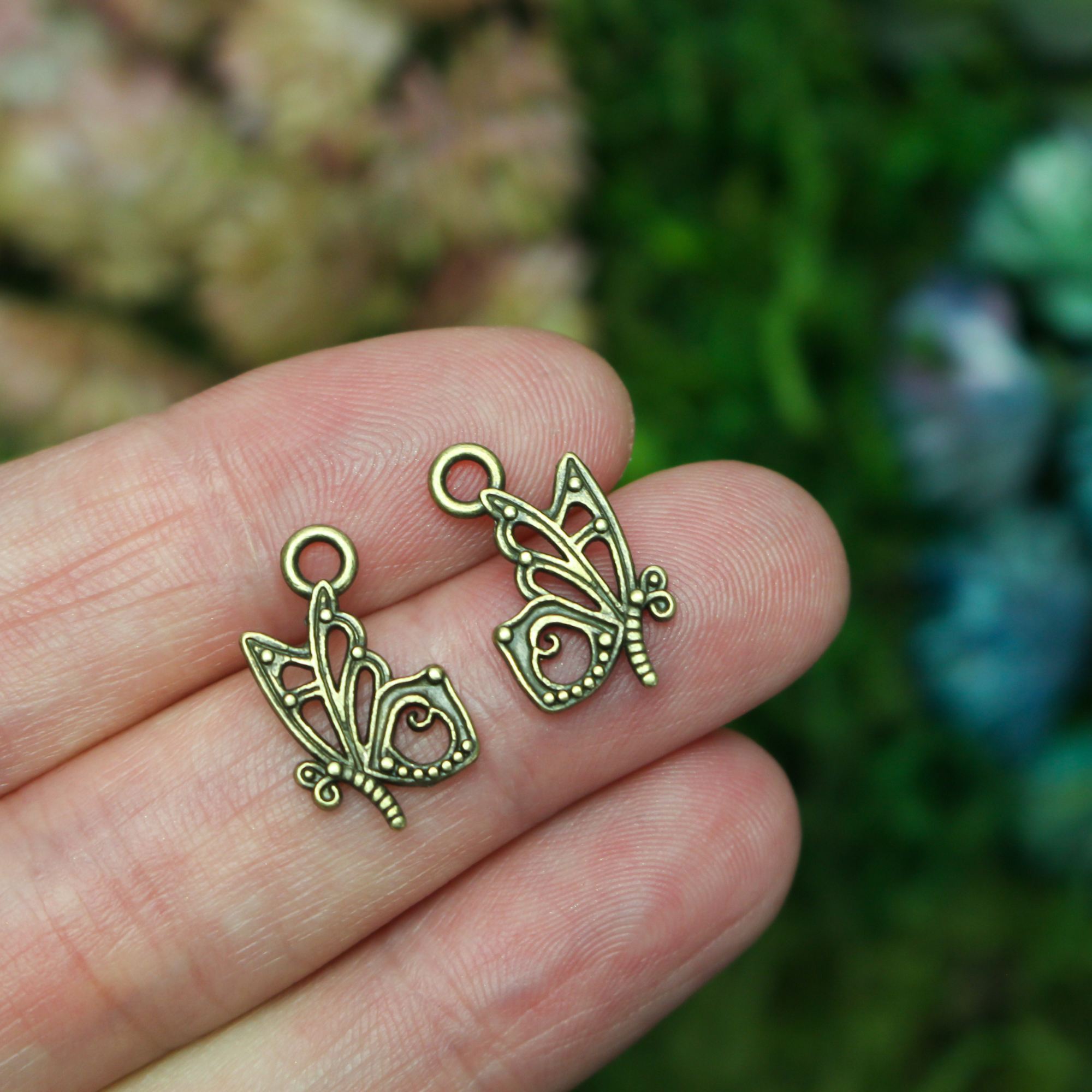 Butterfly charms in an antiqued bronze finish, 16mm long