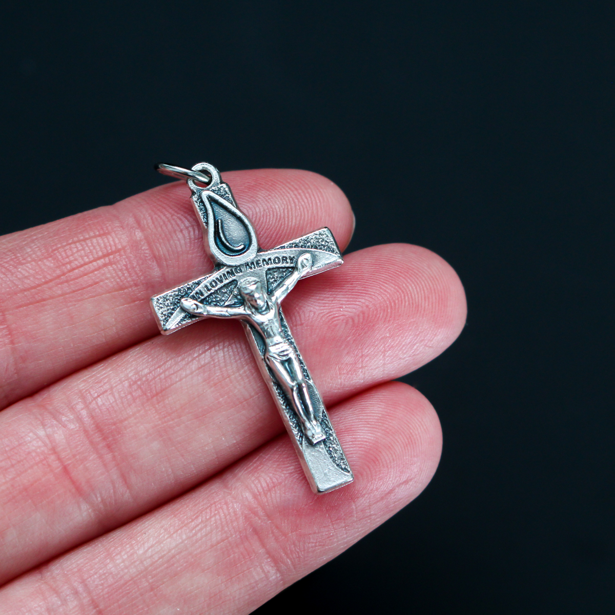 Memorial crucifix cross with a teardrop above Jesus and on the words "In Loving Memory" on the cross beam. The reverse side also is marked "In Loving Memory"