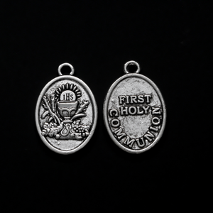 Holy Eucharist medal with "First Holy Communion" on the back