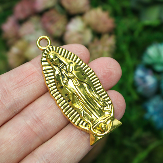 A beautifully detailed pendant of Our Lady of Guadalupe. This large charm is two inches long with a flat, plain back