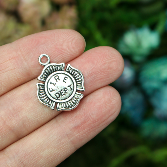 Small silver tone charms in the shape of the Maltese Cross and marked "FIRE DEPT" on the front.