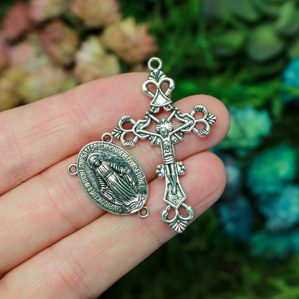 Silver-tone rosary set that includes a Virgin Mary centerpiece and an ornate crucifix cross.