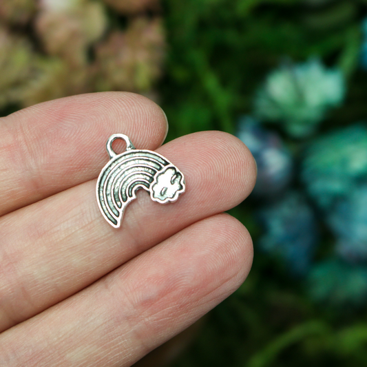 Little rainbow shaped charms with a cloud at the end of the right side
