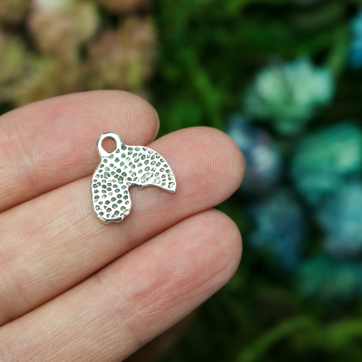 Little rainbow shaped charms with a cloud at the end of the right side
