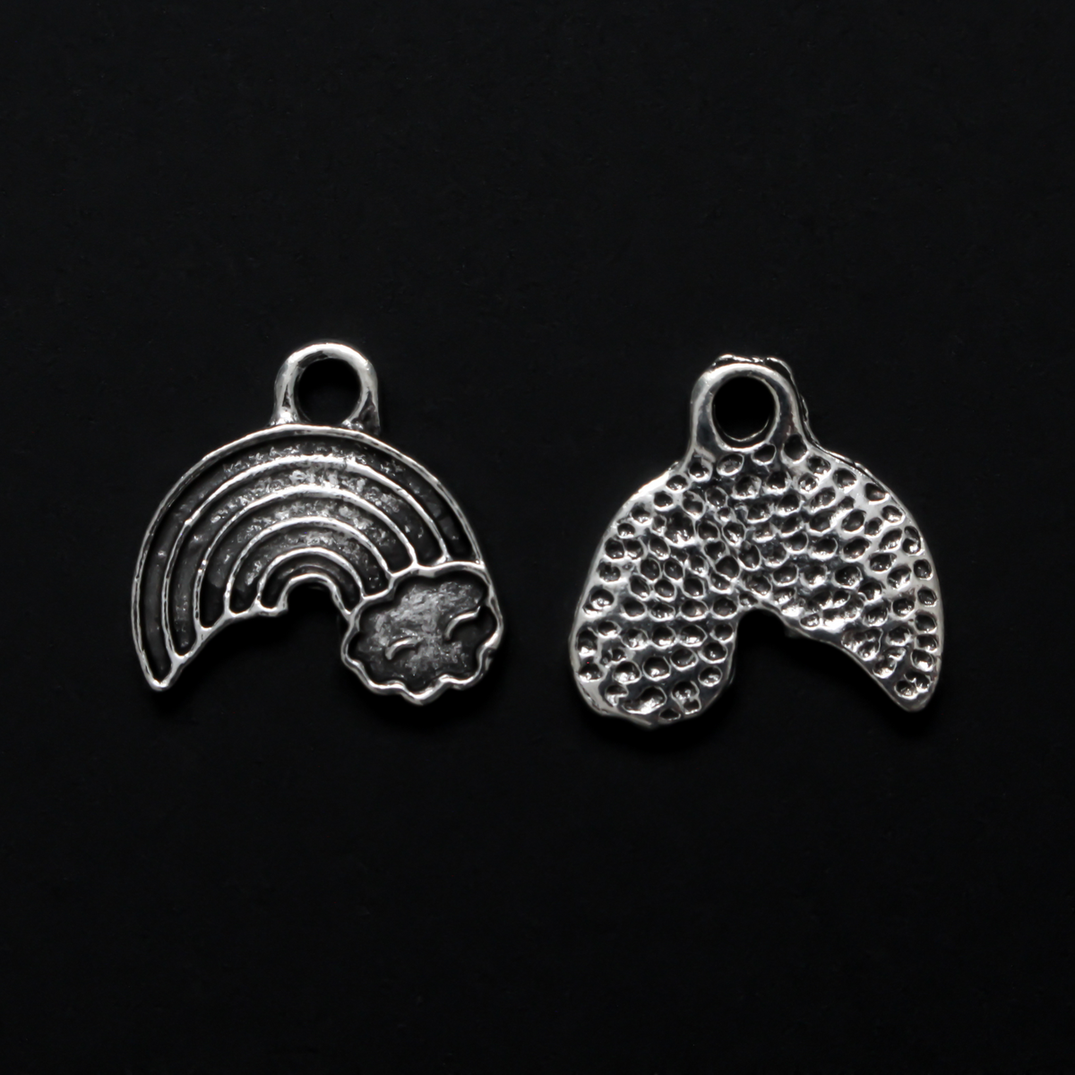 Little rainbow shaped charms with a cloud at the end of the right side