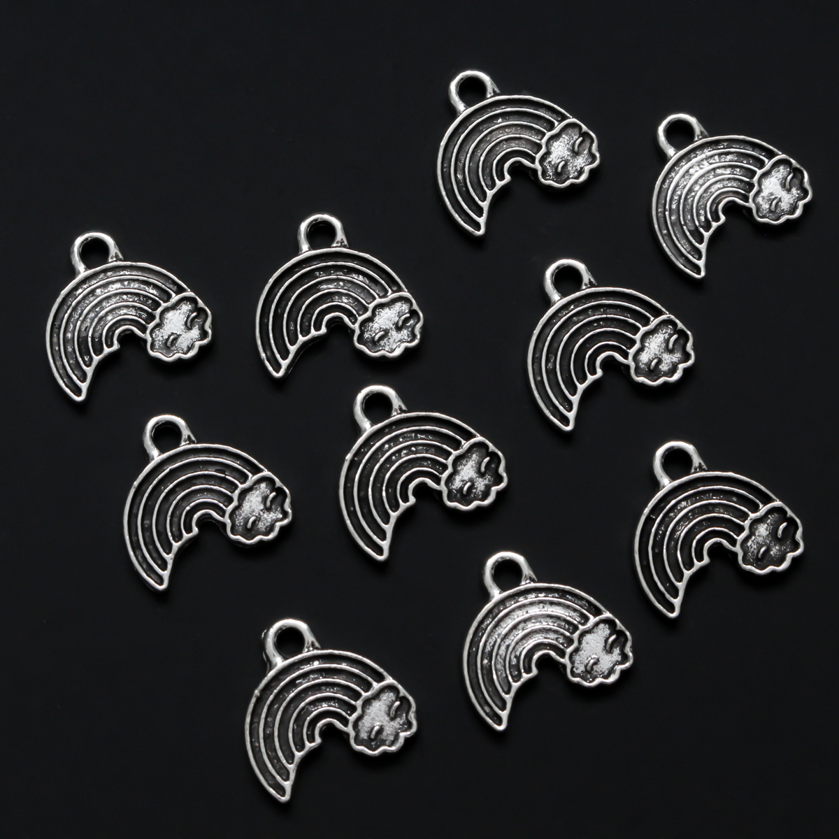 Little rainbow shaped charms with a cloud at the end of the right side