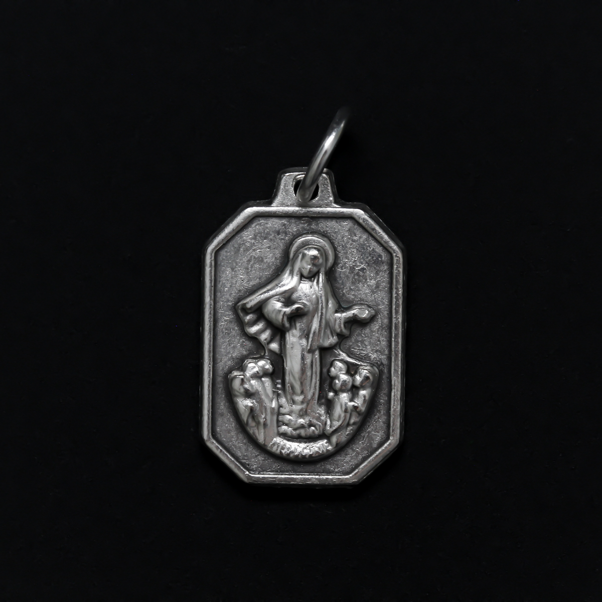 Unique shaped medal with Our Lady of Medjugorje on the front and St. James Church on the back.