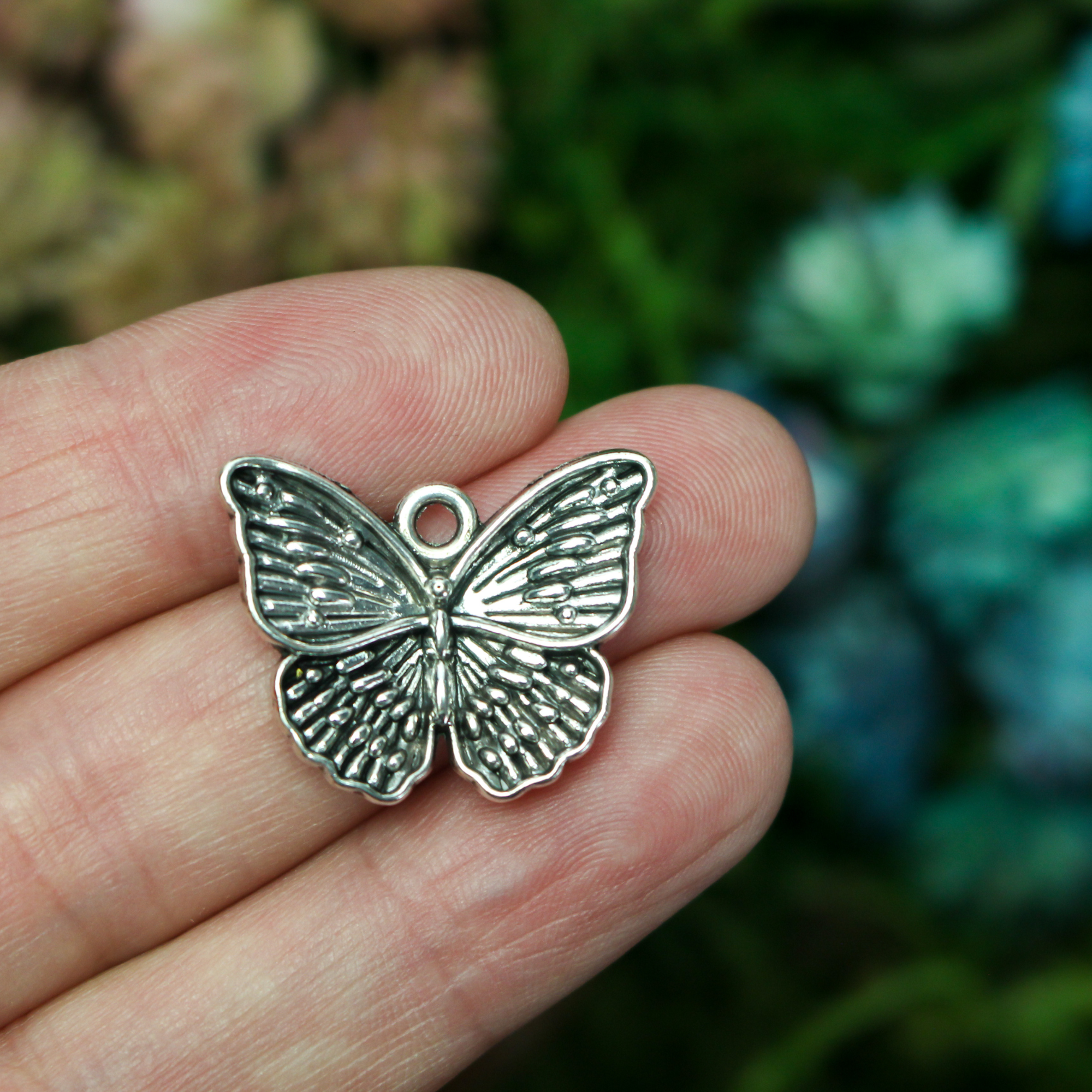 Detailed butterfly charms in an antiqued silver-tone finish, 19.5mm long x 23.5mm wide