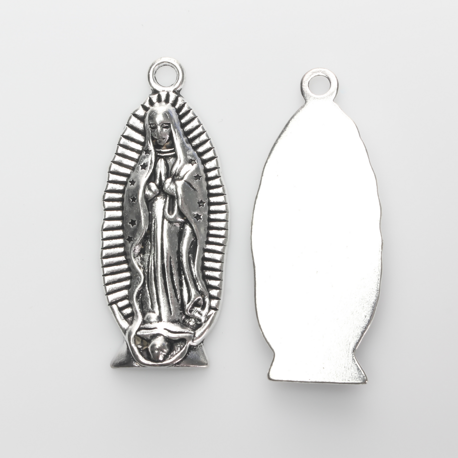 A beautifully detailed pendant of Our Lady of Guadalupe. This large charm is two inches long with a flat, plain back