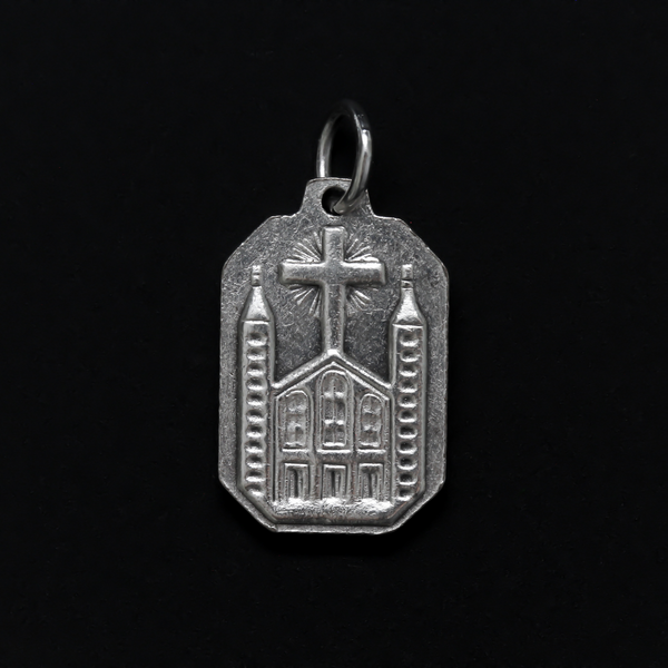 Unique shaped medal with Our Lady of Medjugorje on the front and St. James Church on the back.
