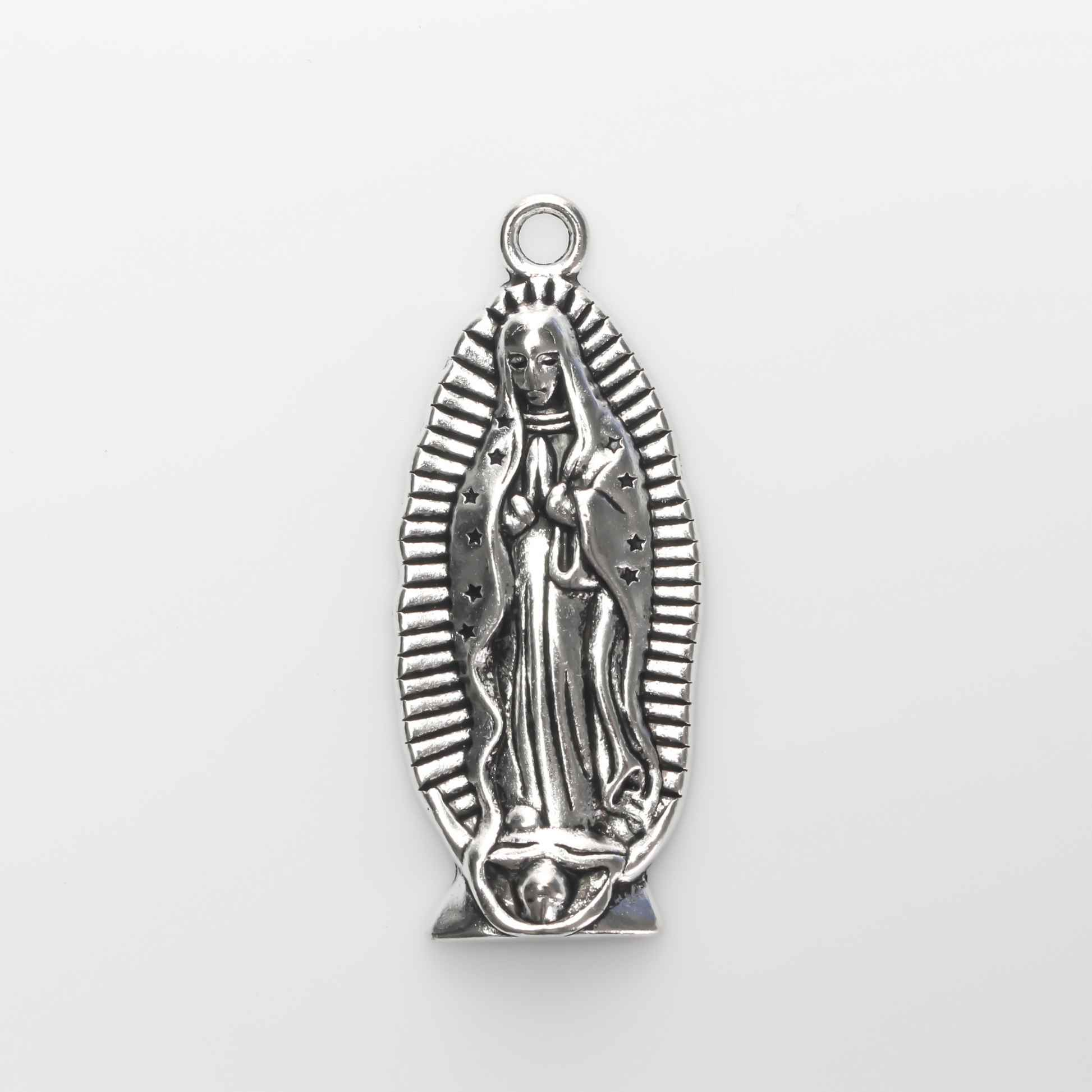 A beautifully detailed pendant of Our Lady of Guadalupe. This large charm is two inches long with a flat, plain back