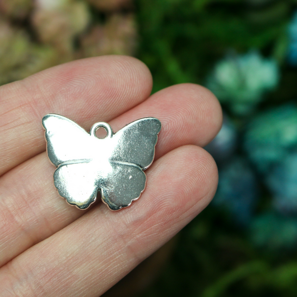 Detailed butterfly charms in an antiqued silver-tone finish, 19.5mm long x 23.5mm wide