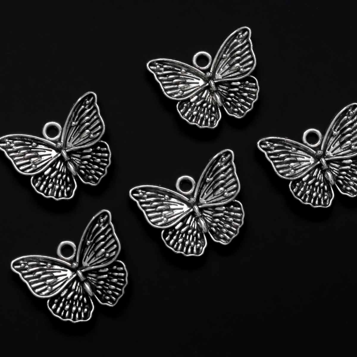 Detailed butterfly charms in an antiqued silver-tone finish, 19.5mm long x 23.5mm wide