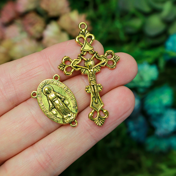 Gold rosary set that includes a Virgin Mary centerpiece and an ornate crucifix cross
