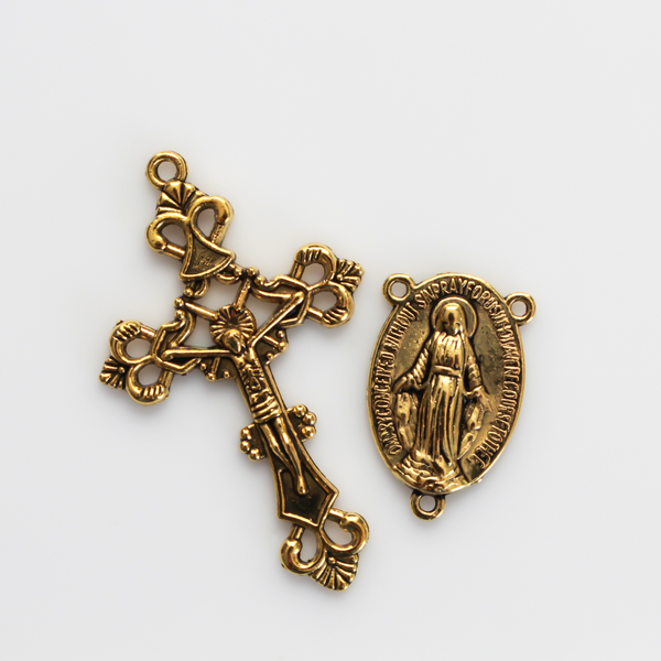 Gold rosary set that includes a Virgin Mary centerpiece and an ornate crucifix cross