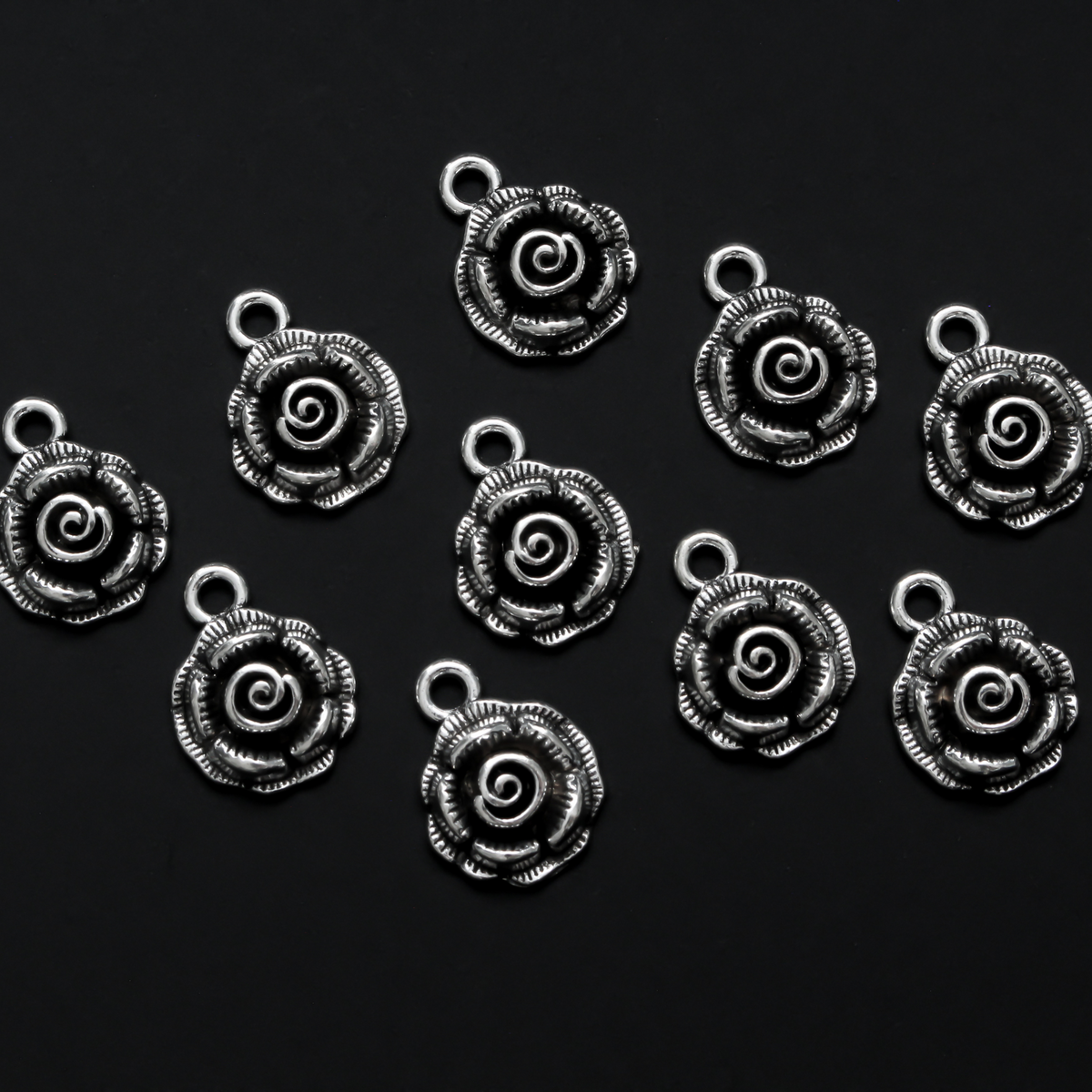 Small round rose charms in an antique silver tone color, 17mm long, 14mm wide, 5mm thick