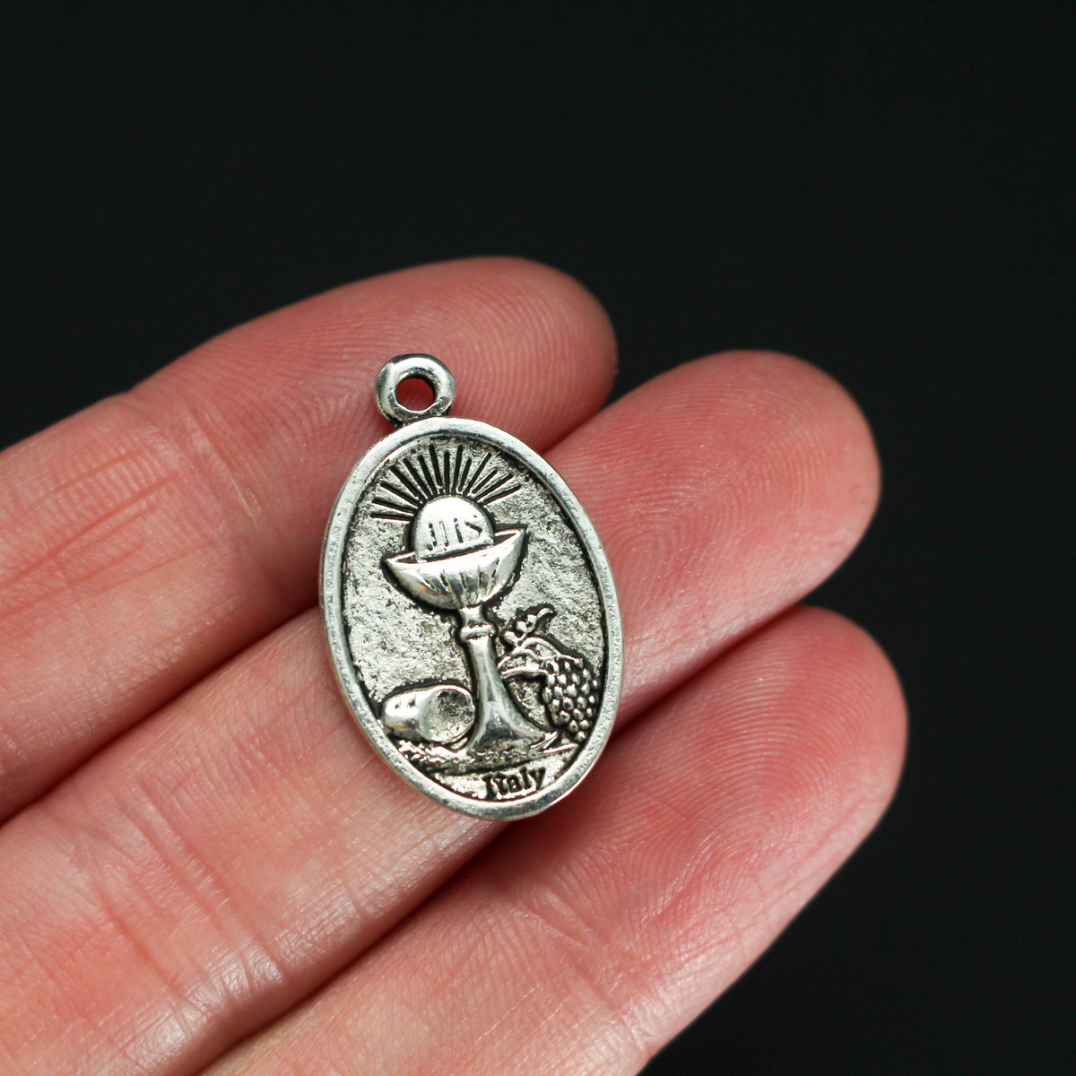 Holy Eucharist with Holy Spirit medal, one inch long silver tone color