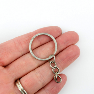 Silver-tone split keyring with an attached chain.