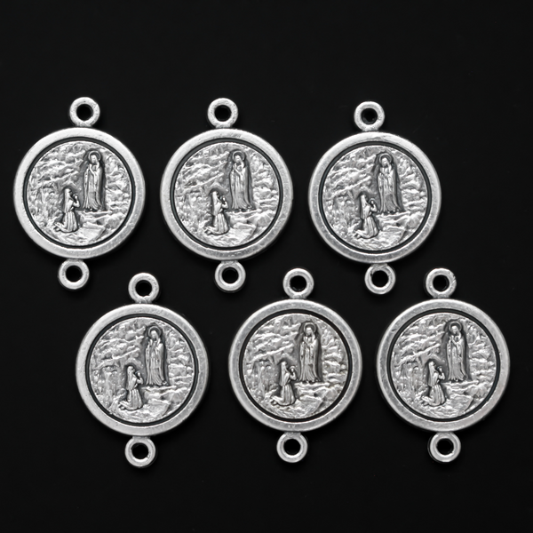 14mm St. Bernadette round flat connector links that are silver oxidized plating on a base metal
