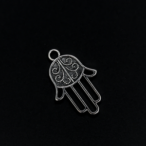 Silver tone Hamsa hand charm with an open design on the fingers, 22mm long by 15mm wide
