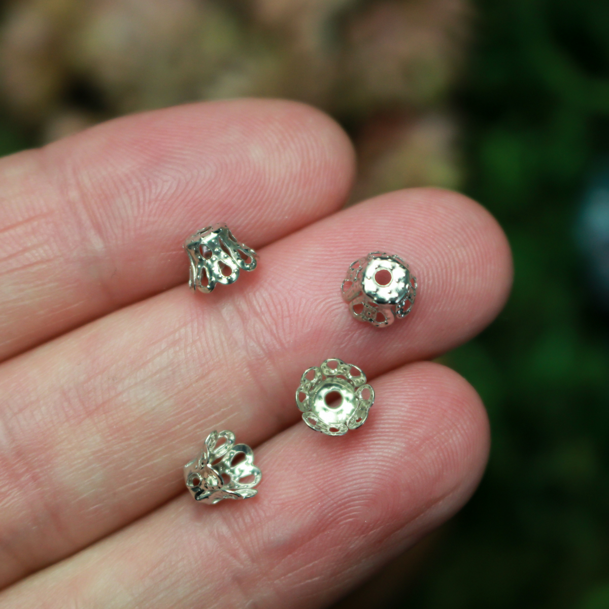Filigree bead cap cups that are 5mm long by 6mm in diameter at the opening. They can fit beads 6mm - 8mm. Antique silver tone color