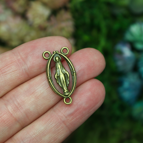 Bronze Miraculous Mary rosary centerpiece with a cutout design, 25mm long.