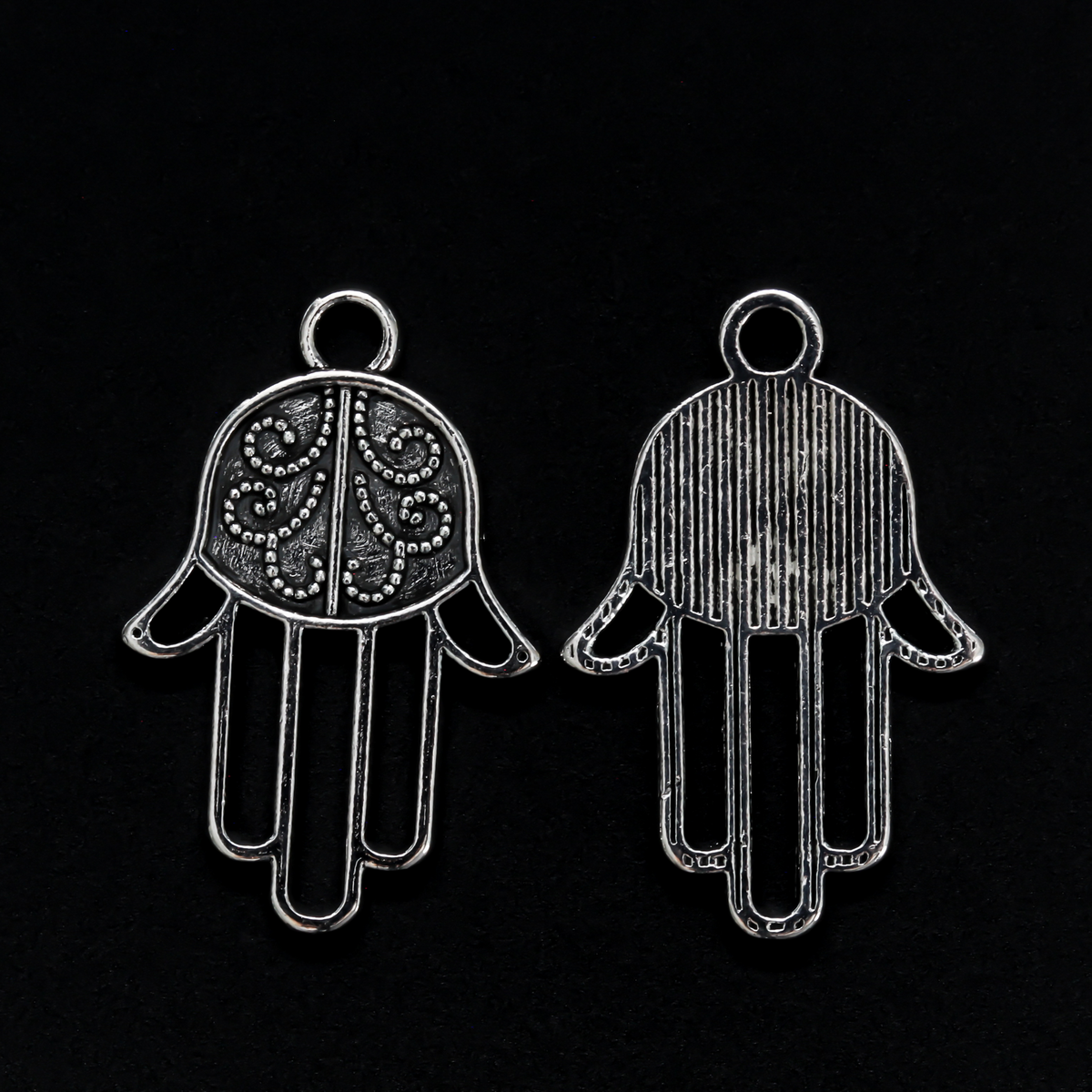 Silver tone Hamsa hand charm with an open design on the fingers, 22mm long by 15mm wide
