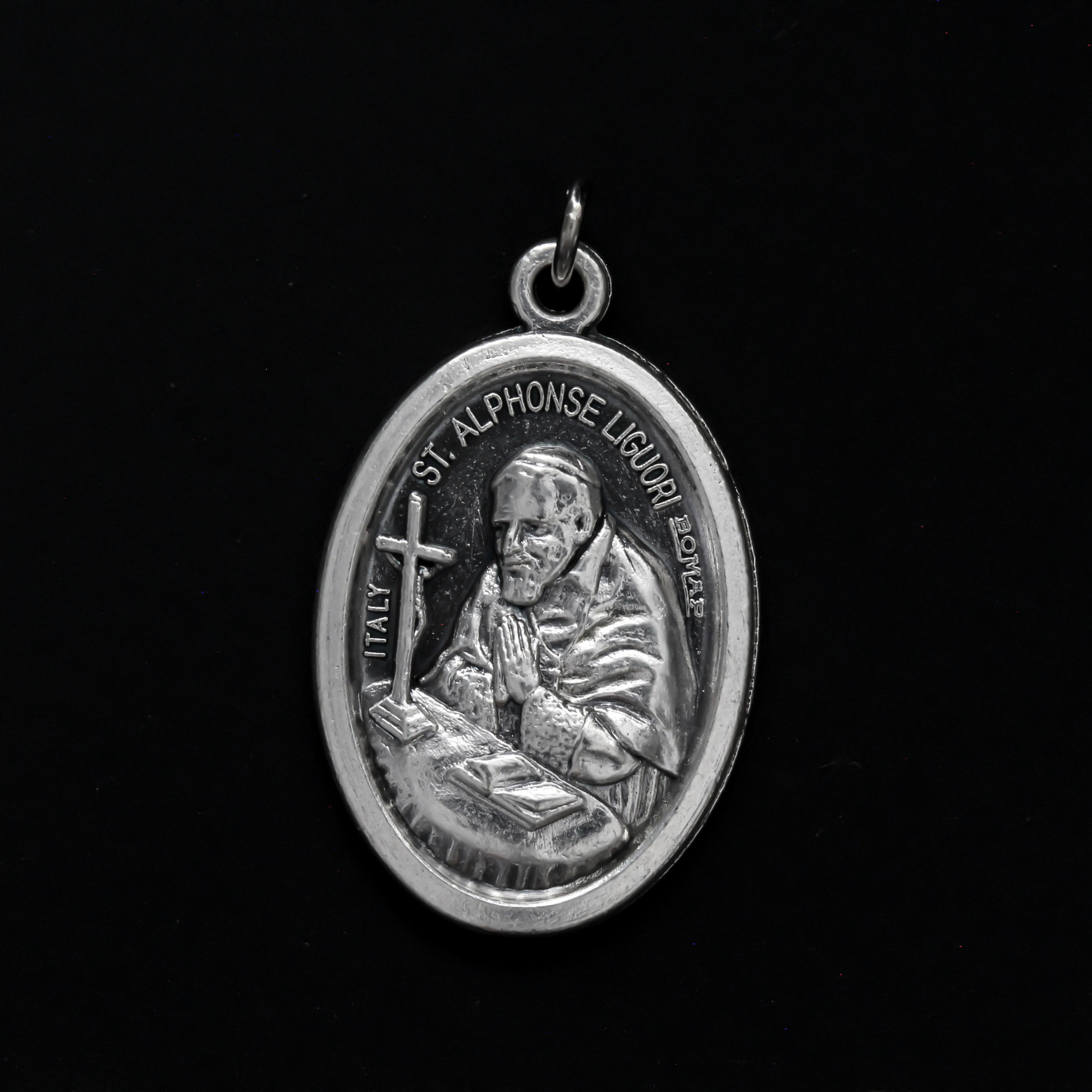 Saint Alphonsus Ligouri one inch oval medal. The front of the medal depicts the Saint and the reverse is marked "Pray For Us"
