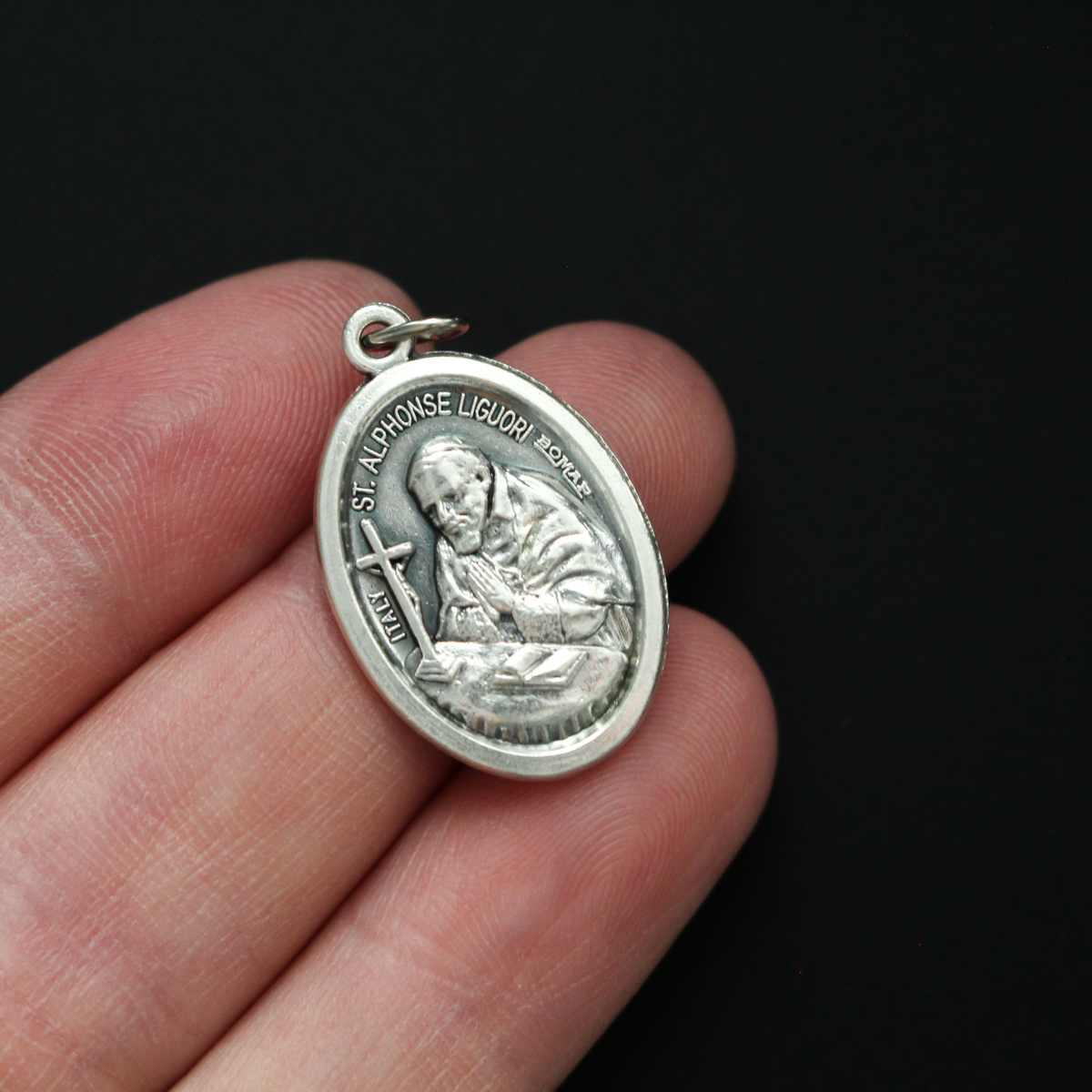 Saint Alphonsus Ligouri one inch oval medal. The front of the medal depicts the Saint and the reverse is marked "Pray For Us"