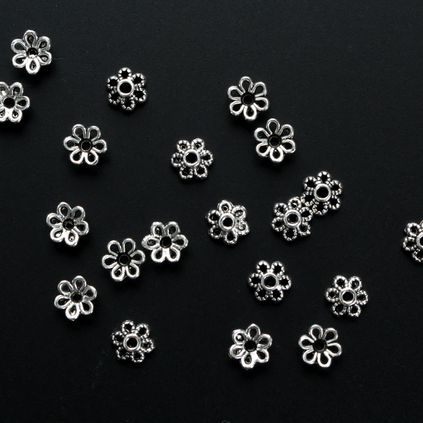 Flower shaped zinc alloy antiqued silver bead caps that are 6mm by 2.3mm, they can fit beads 8mm - 10mm