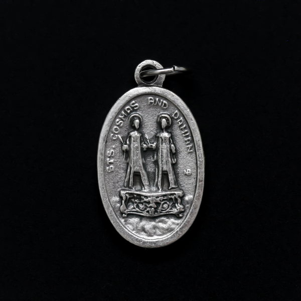 Saints Cosmas and Damian oval medal that depicts the brothers on the front and "Pray For Us" on the back