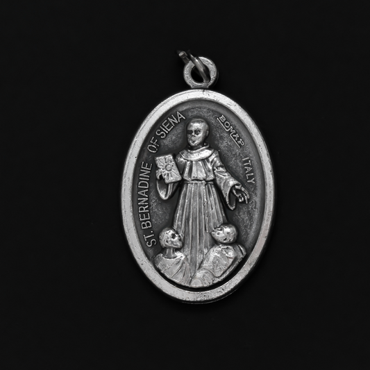 Saint Bernardine of Siena medal that depicts the saint on the front and is marked "Pray For Us" on the back