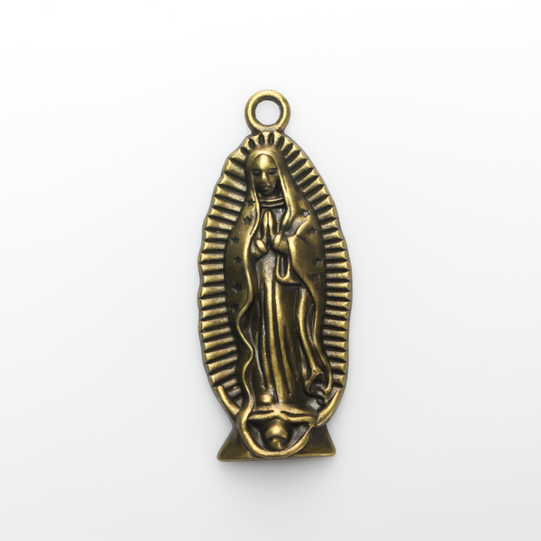 A beautifully detailed pendant of Our Lady of Guadalupe. This large charm is two inches long with a flat, plain back