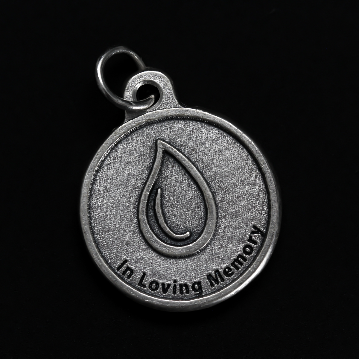 Memorial charm with a teardrop on the front with the words "In Loving Memory" beneath it. The reverse side is marked "A Tear, Lost, but never forgotten". 