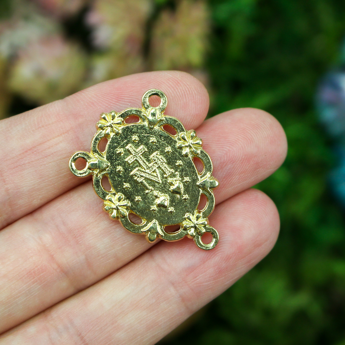 gold tone Miraculous Medal rosary centerpiece that has gorgeous details with filigree cut out design and floral detailing