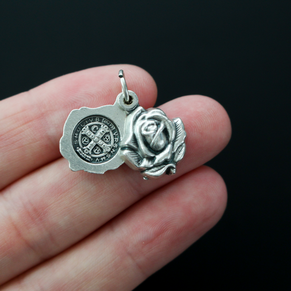 Saint Benedict medal rose locket that slides open to reveal the medal inside. It's a double-sided locket with a rose on both sides