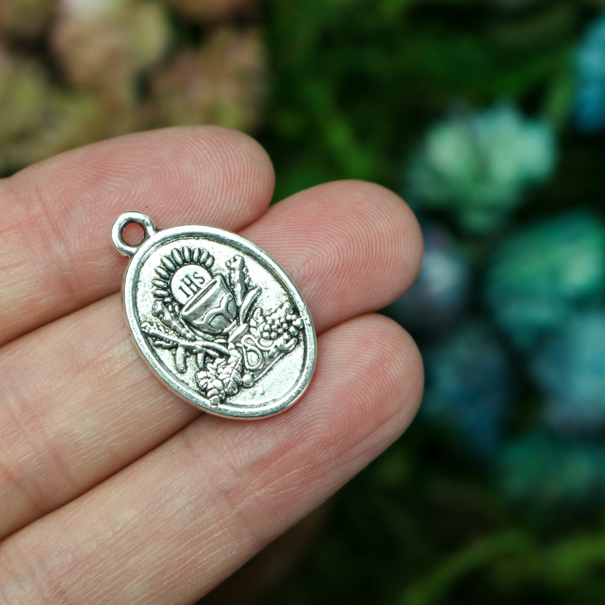 Holy Eucharist medal with "First Holy Communion" on the back