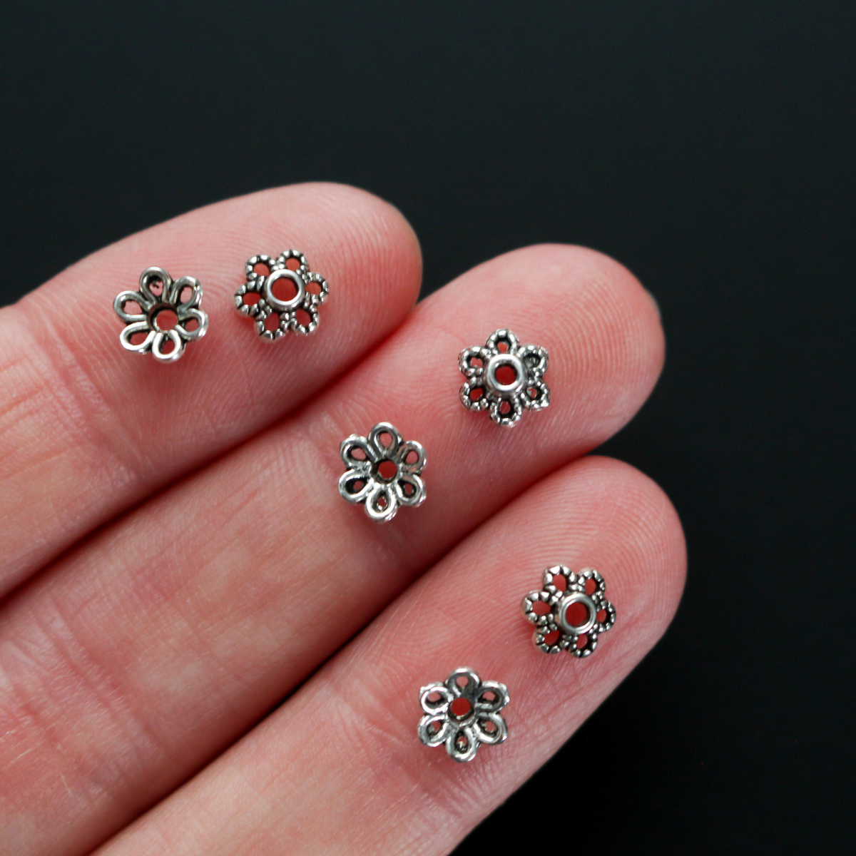 Flower shaped zinc alloy antiqued silver bead caps that are 6mm by 2.3mm, they can fit beads 8mm - 10mm