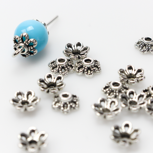 Flower shaped zinc alloy antiqued silver bead caps that are 6mm by 2.3mm, they can fit beads 8mm - 10mm