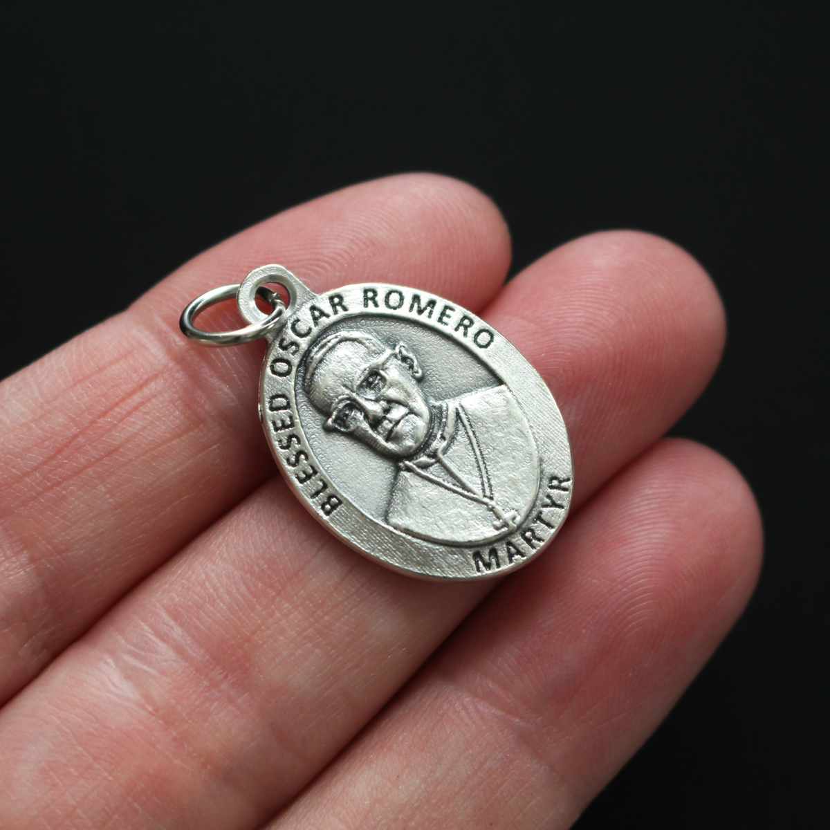 Blessed Óscar Romero medal that depicts the saint on the front and the reverse side is marked "Pray For Us"