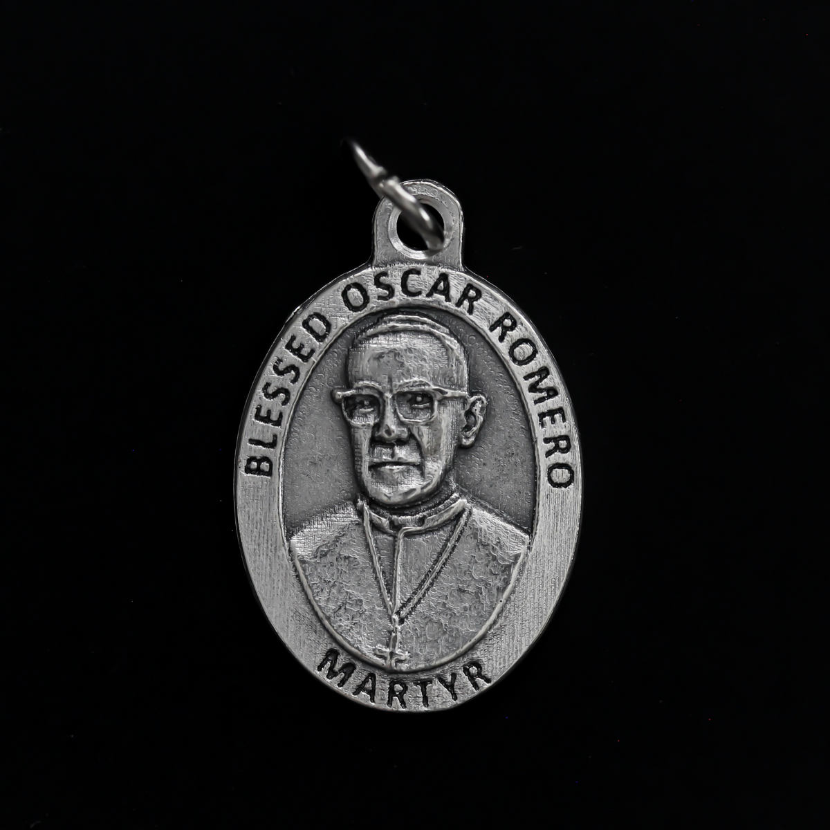 Blessed Óscar Romero medal that depicts the saint on the front and the reverse side is marked "Pray For Us"