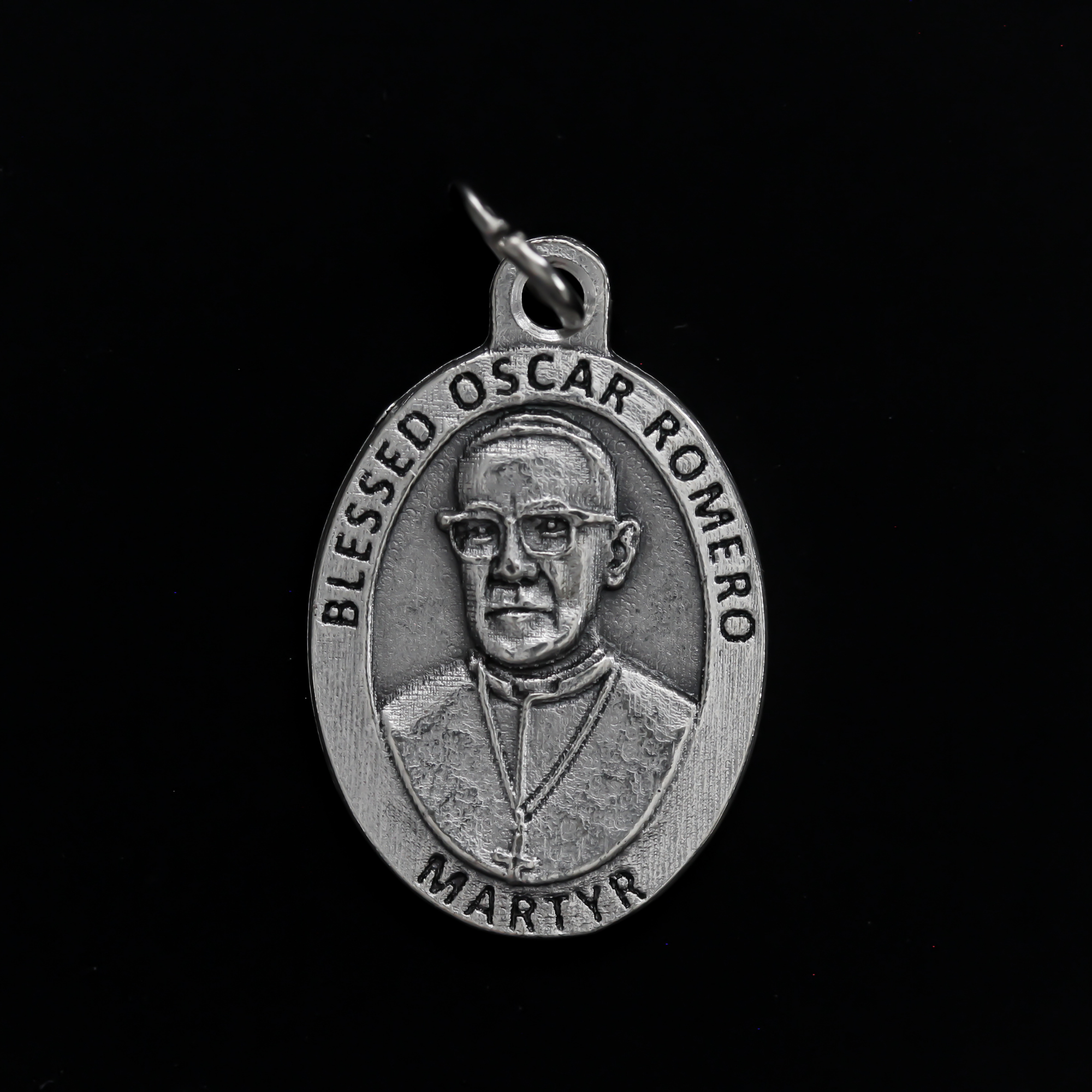 Blessed Óscar Romero medal that depicts the saint on the front and the reverse side is marked "Pray For Us"
