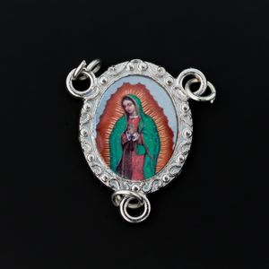 Rosary center that has a color image of Our Lady of Guadalupe inlaid in a silver oxidized center with a scroll detail on the edge